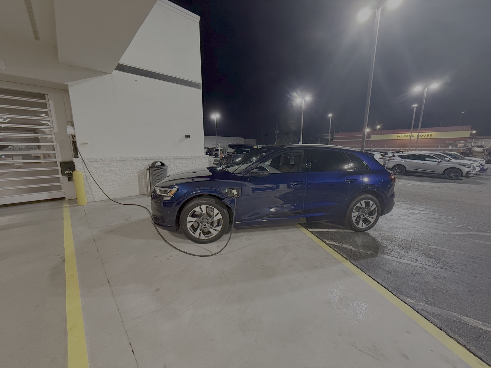 The Audi e-tron charging at night, mid-relocation